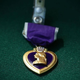 Purple heart on dark green background